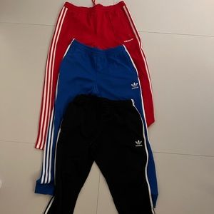 3 pair of track pants. Black, Blue and Red Adidas Track Pants